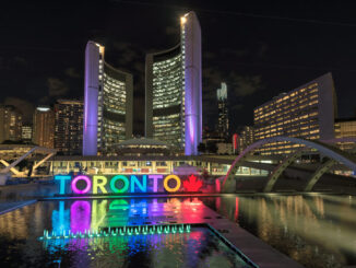Toronto City Hall and Toronto sign in Nathan Phillips Square at night, Ontario, Canada.