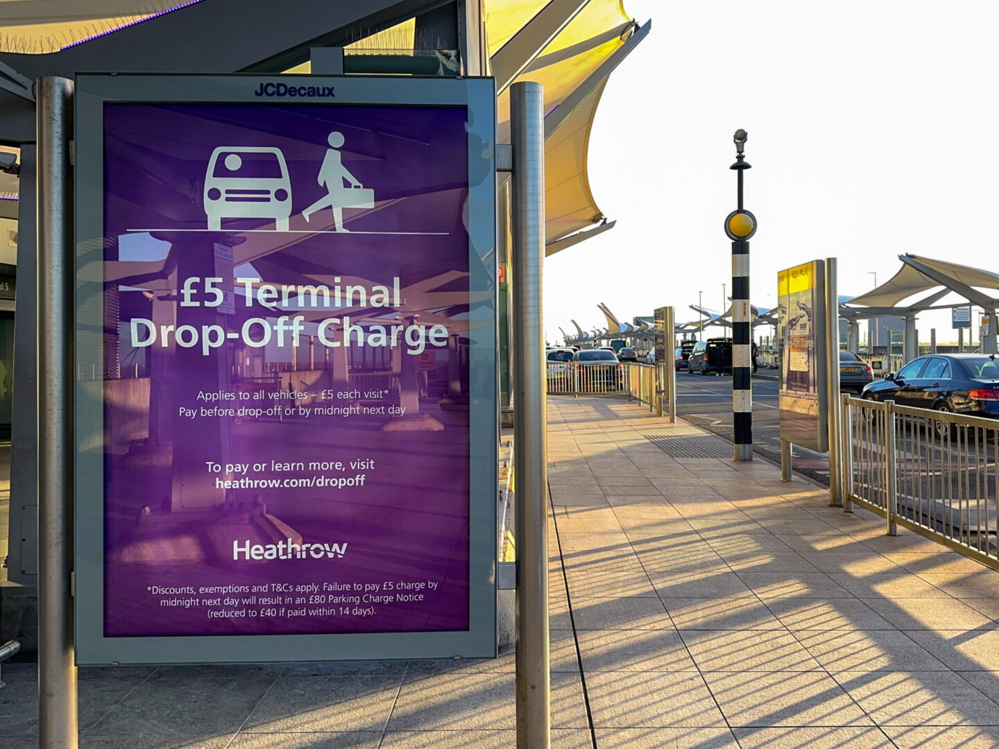 Warning sign informing drivers of a charge to drop off passengers at Terminal 5 at Heathrow Airport, now £6