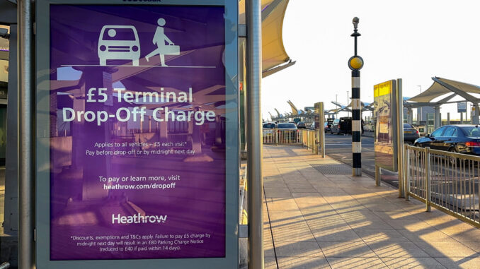 Warning sign informing drivers of a charge to drop off passengers at Terminal 5 at Heathrow Airport, now £6