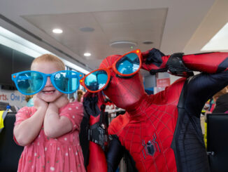 Spider-Man and a child who lives with a life shortening condition in Glasgow Airport's Campsie Lounge
